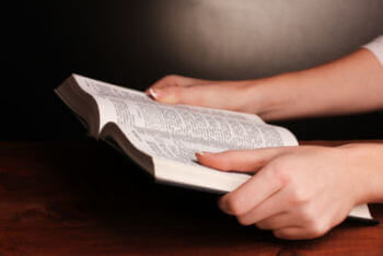 Hands holding russian holy bible