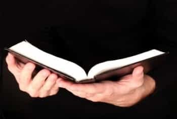 man holding a black bible