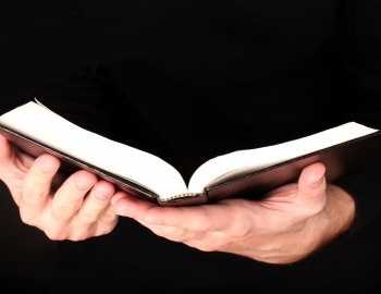 man holding a black bible