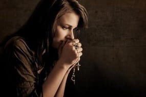 Anxious Girl Praying the Rosary