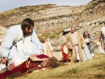 Crowd Watches As Jesus Helps Person Lying On Ground