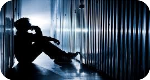 young man in dark sitting on the floor